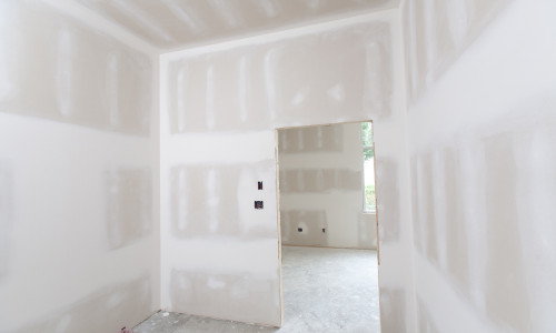 Drywall installed and spackled inside of rooms being renovated