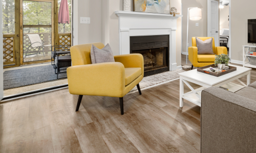 A living room with light wooden flooring