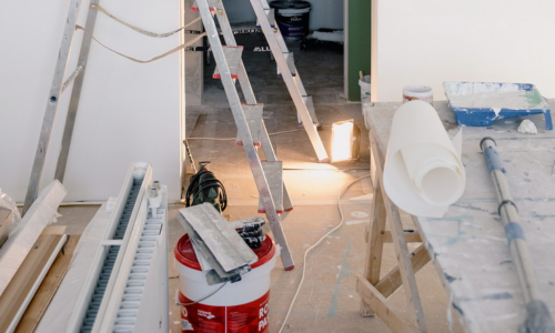 A room being renovated with contractor supplies spread in various places