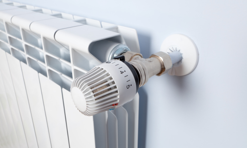 A close up of a radiator with an adjustment knob 